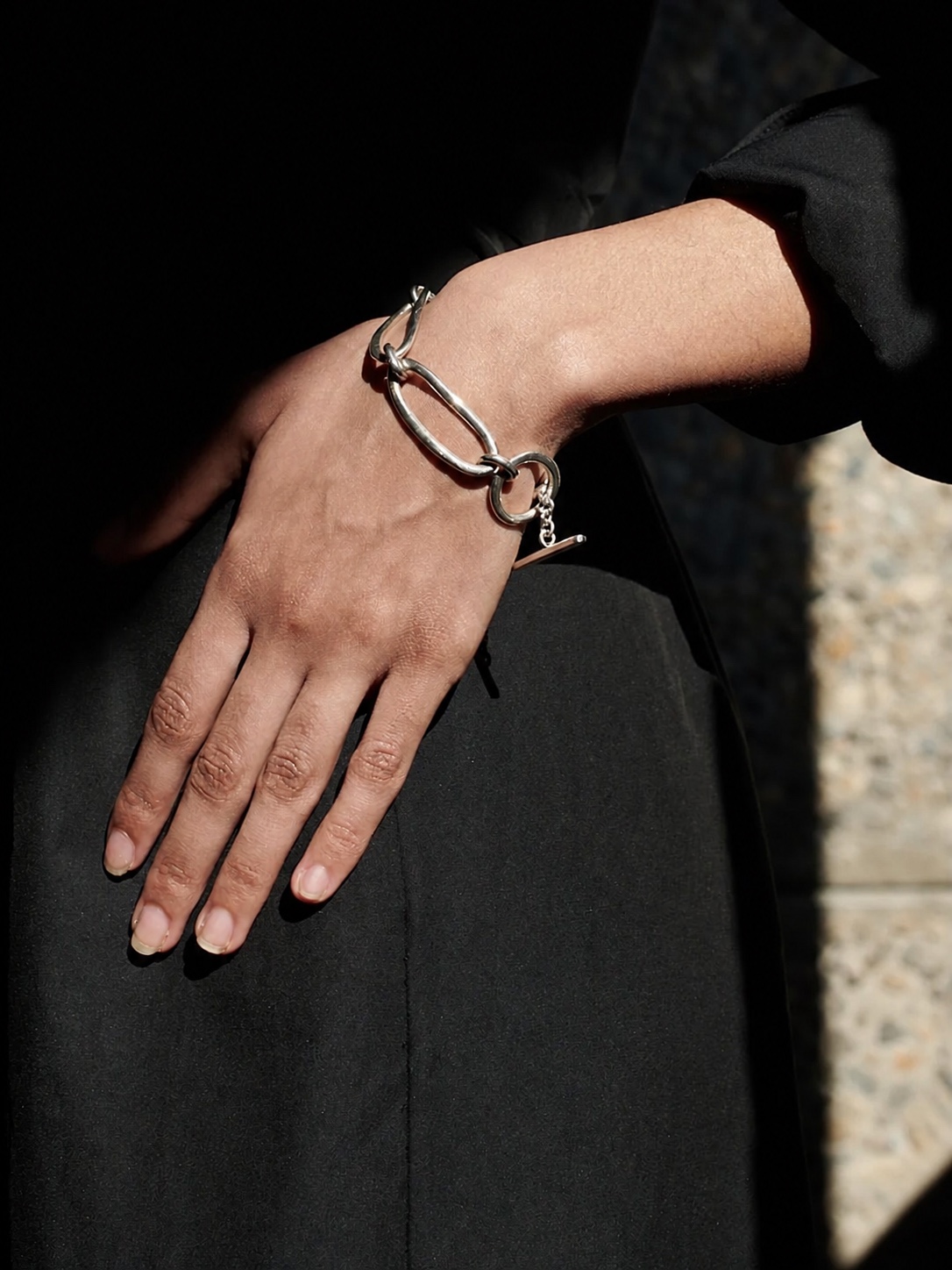 AGMES silver earrings against a dark background