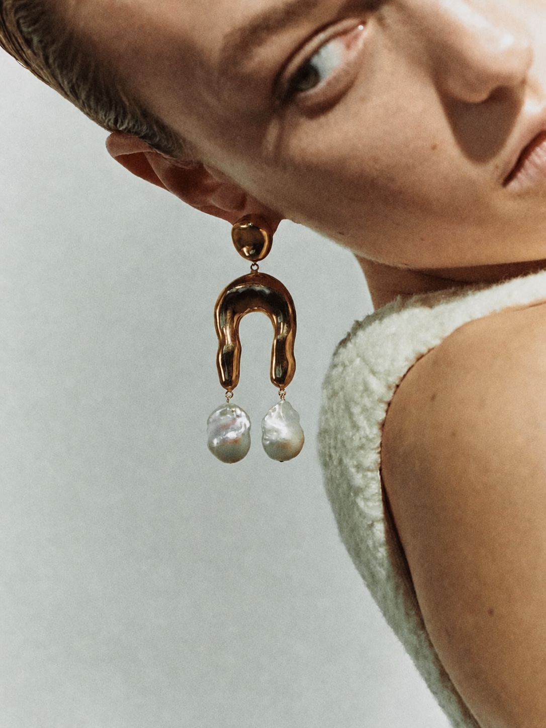 AGMES sculptural earrings in a close-up portrait