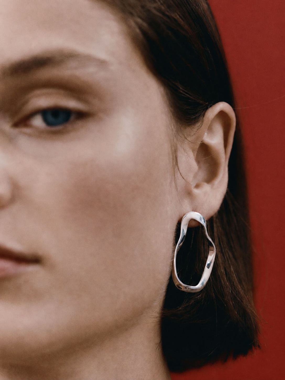 AGMES sculptural silver earring on the ear