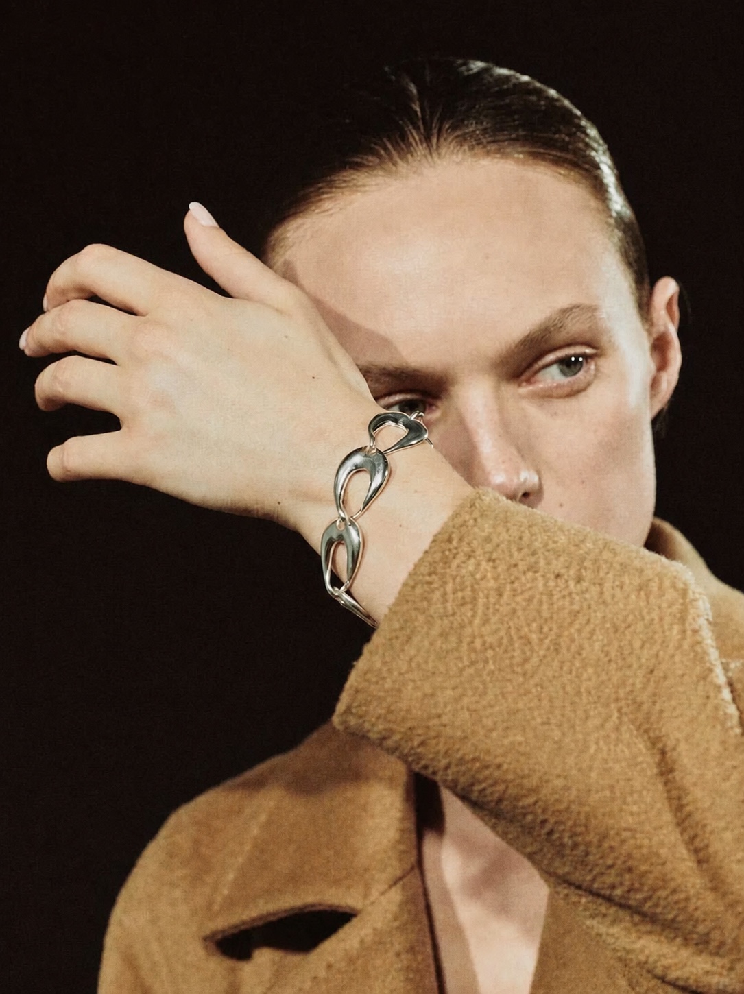 AGMES linked silver bracelet worn with a camel coat