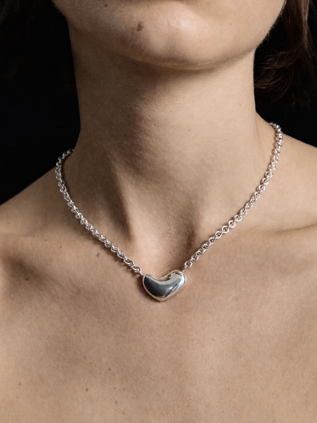 AGMES sculptural silver earrings worn in profile