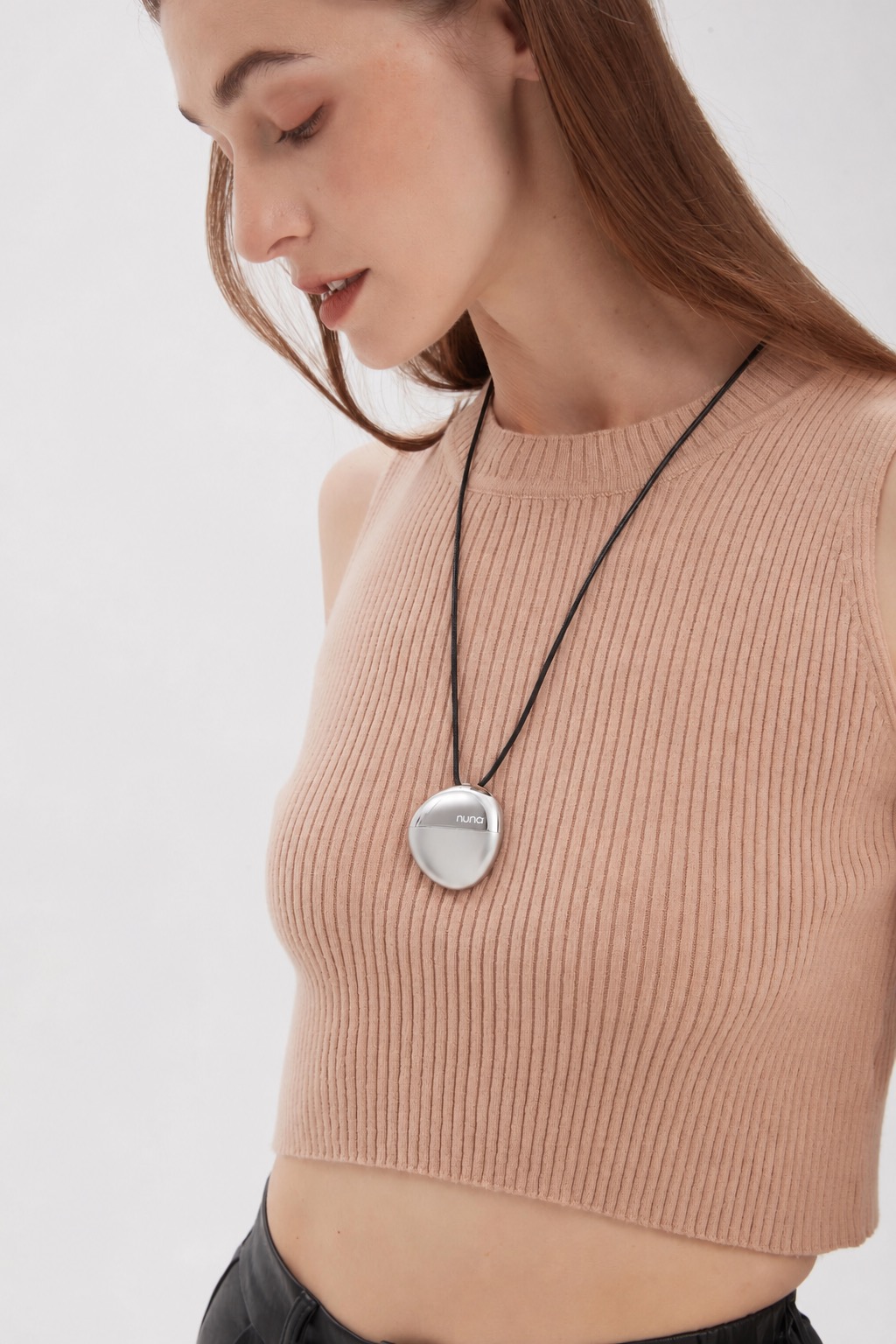 AI mood pendant worn with a peach ribbed sleeveless top