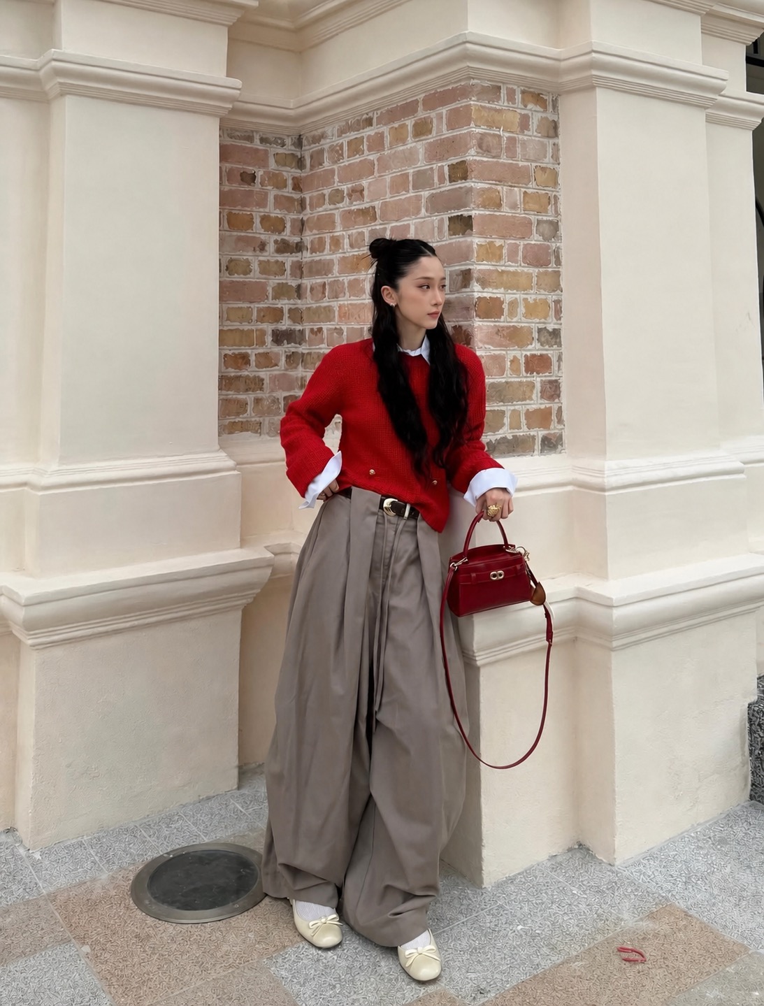 black crop top paired with loose grey cargo pants and a shoulder bag