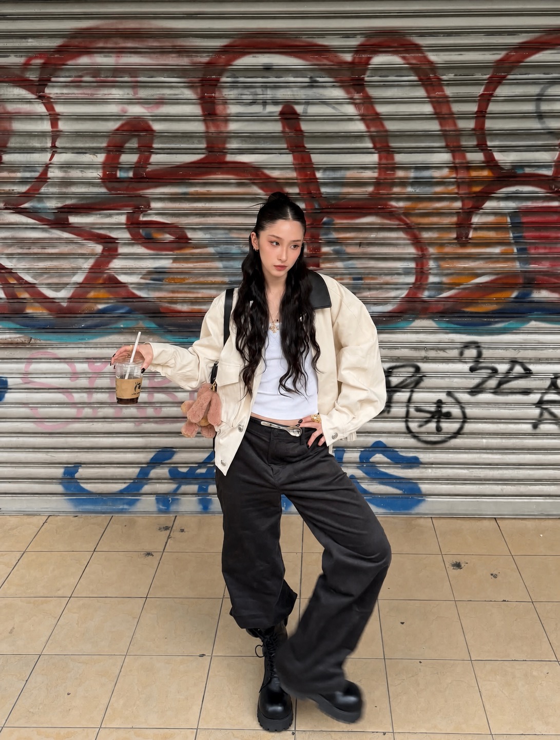 white fitted tee worn with washed baggy jeans and a soft handbag