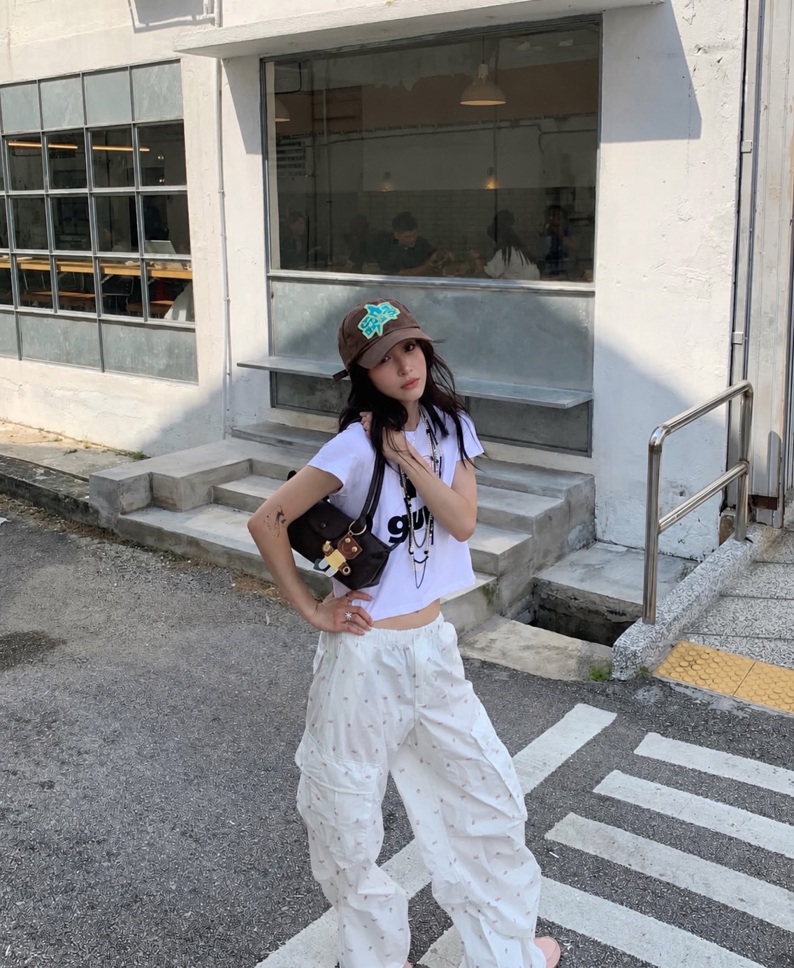 low-saturation streetwear outfit with a fitted top and relaxed trousers