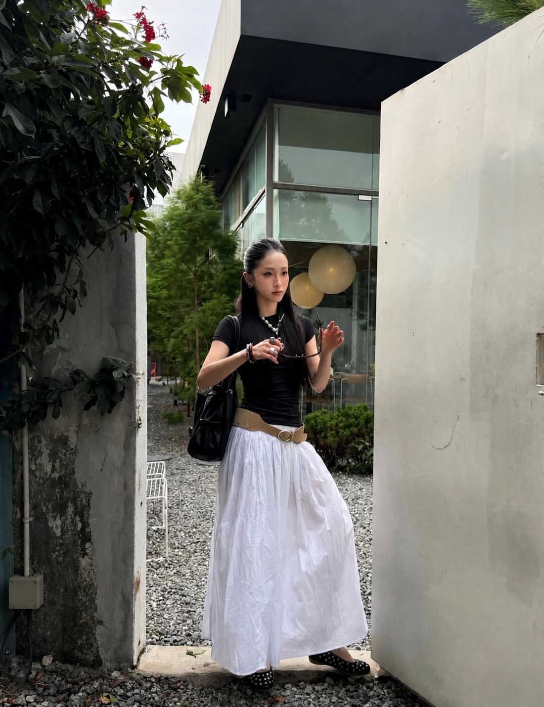 black and white casual outfit with a long skirt and flat shoes