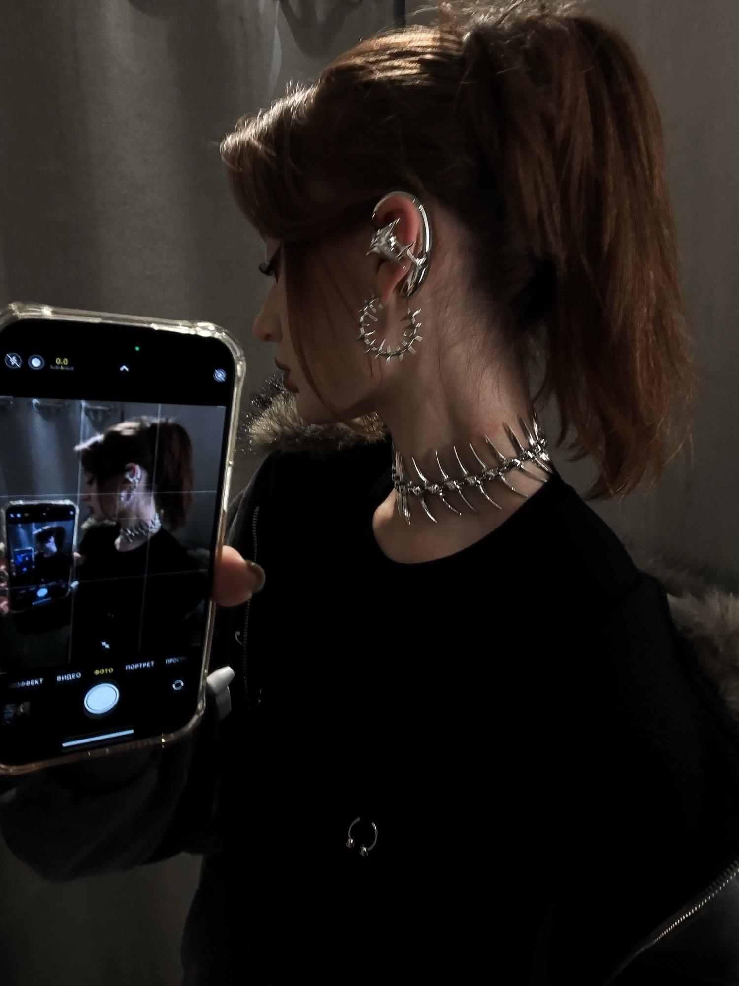 Black, white, and silver NEBULA open earphones presented with their case and product materials on a dark surface.