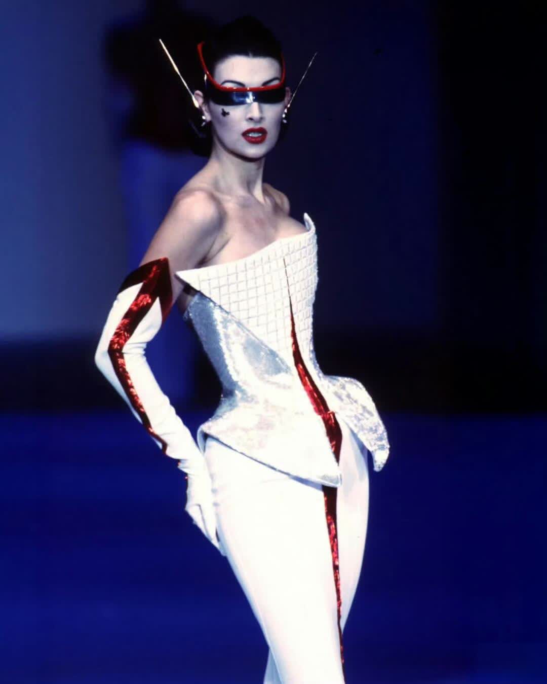 Mugler Fall 1997 couture look with white sculptural corset and red mirrored goggles