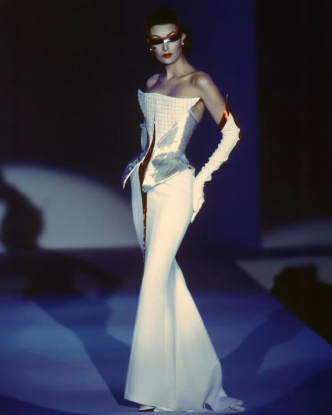 Mugler couture runway image with sculptural corsetry and space age stage light