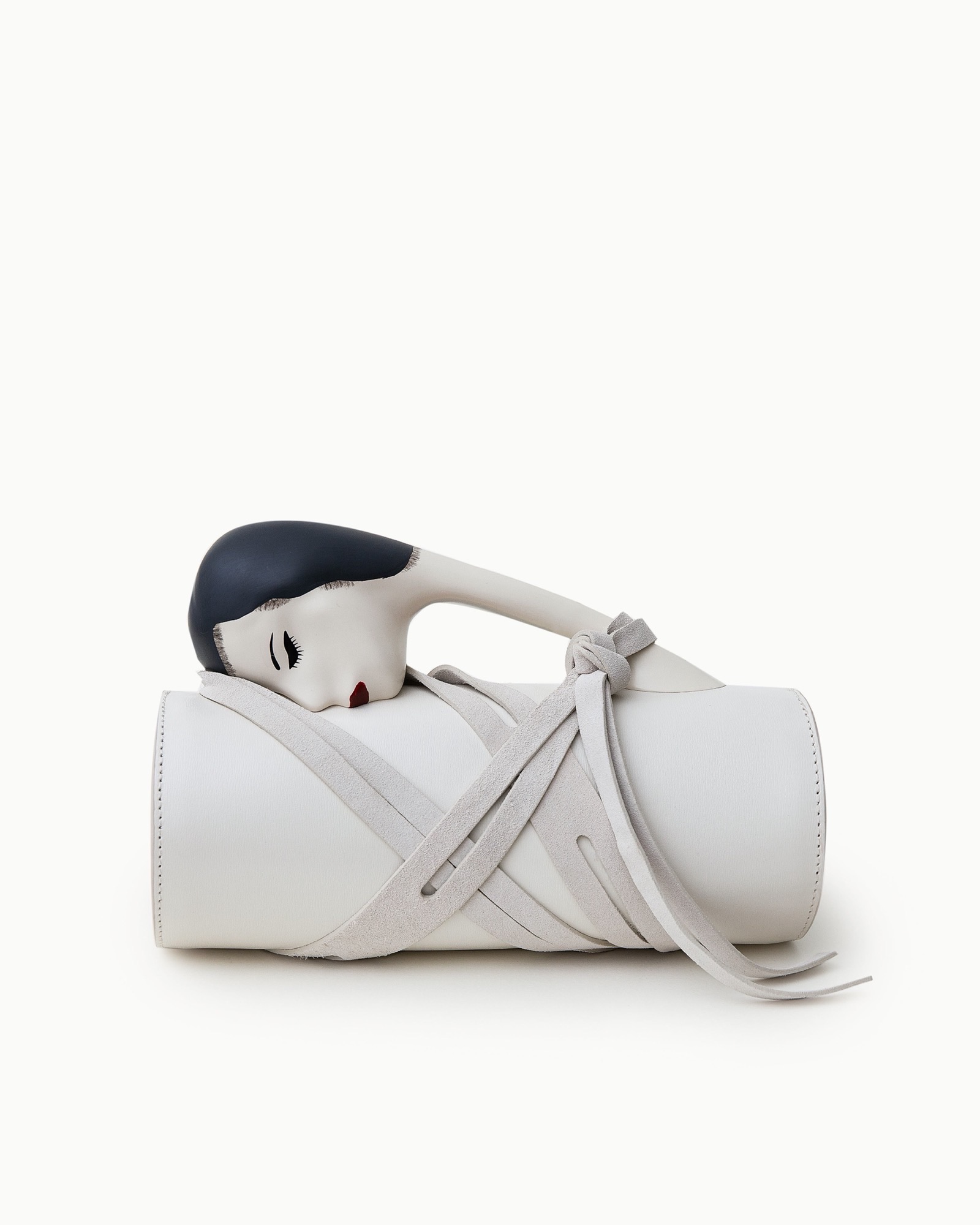 Puppets and Puppets white sculptural bag with a curved object-like form