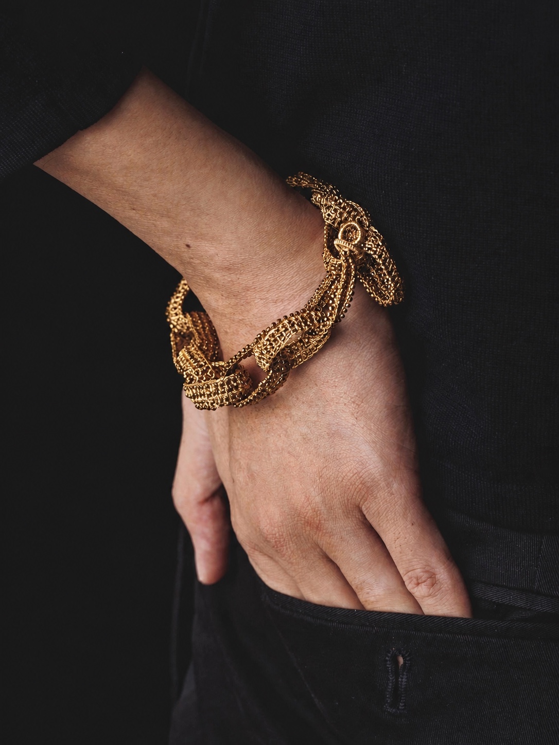 FUA gold beaded bracelet worn on the wrist