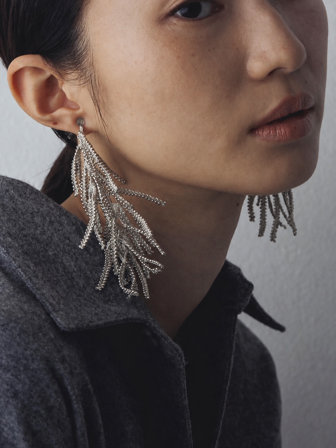 FUA pearl choker and beaded earrings worn in profile