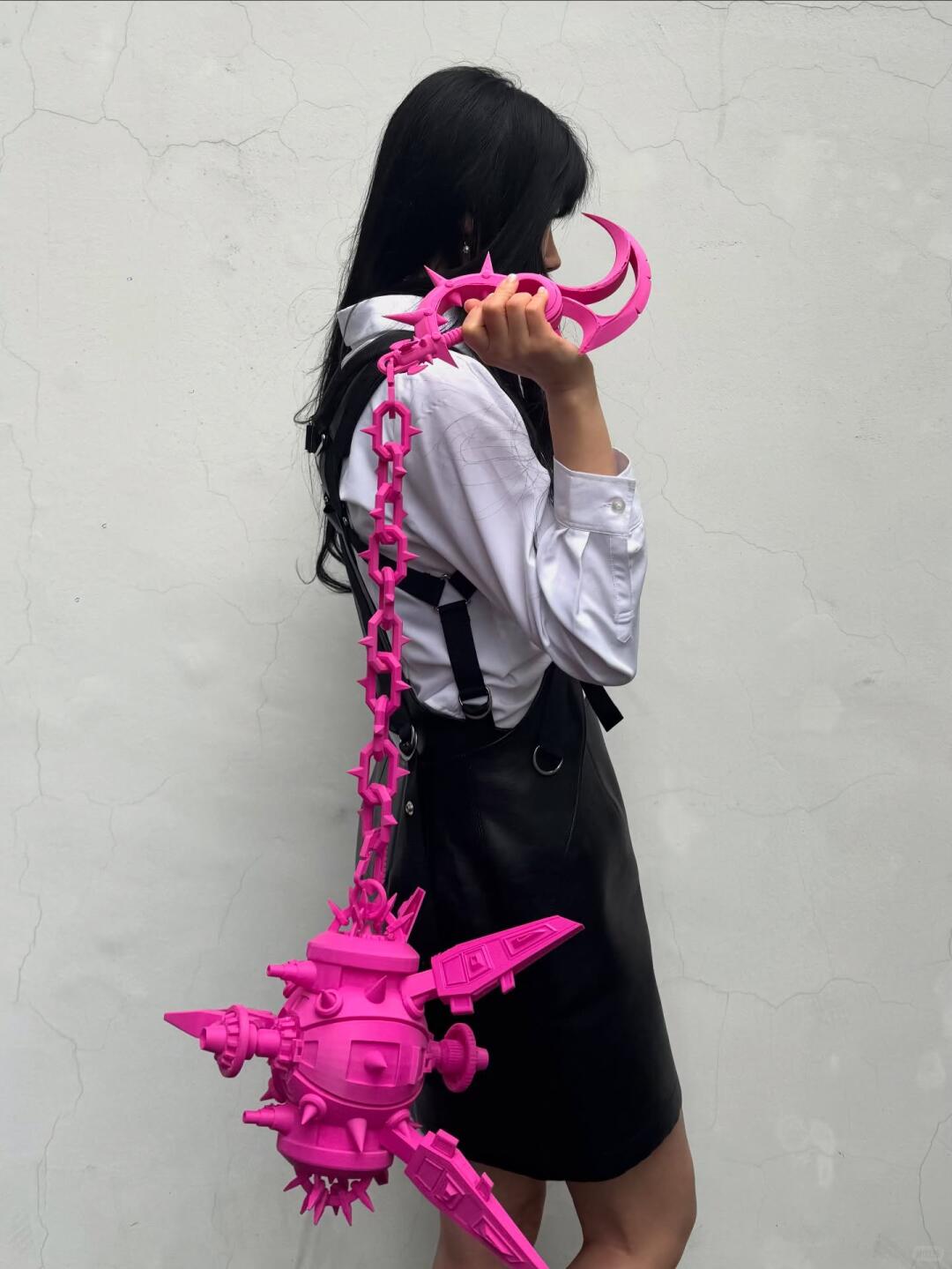Pink spiked chain bag styled with a simple black-and-white outfit