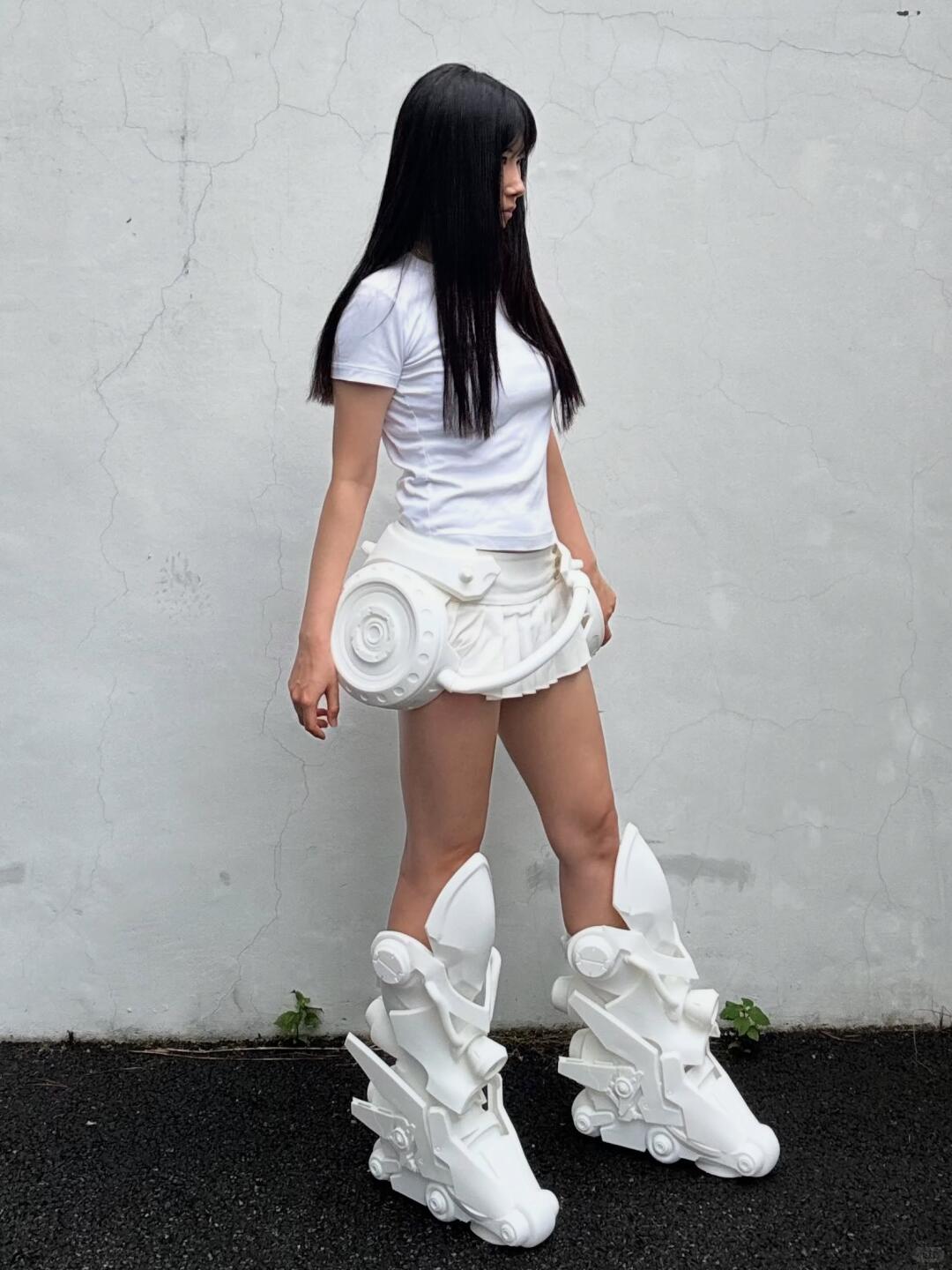 Oversized white mechanical boots styled with a white top and skirt