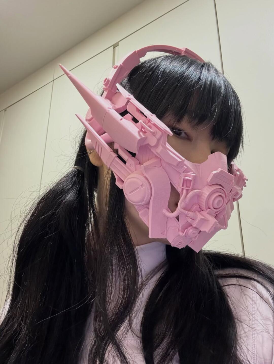 Close view of a pink spiked mechanical face mask