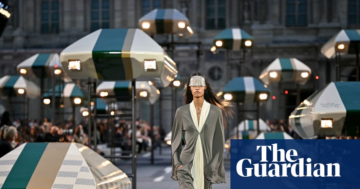Louis Vuitton future-city runway with suspended Damier-check flying-car installations.