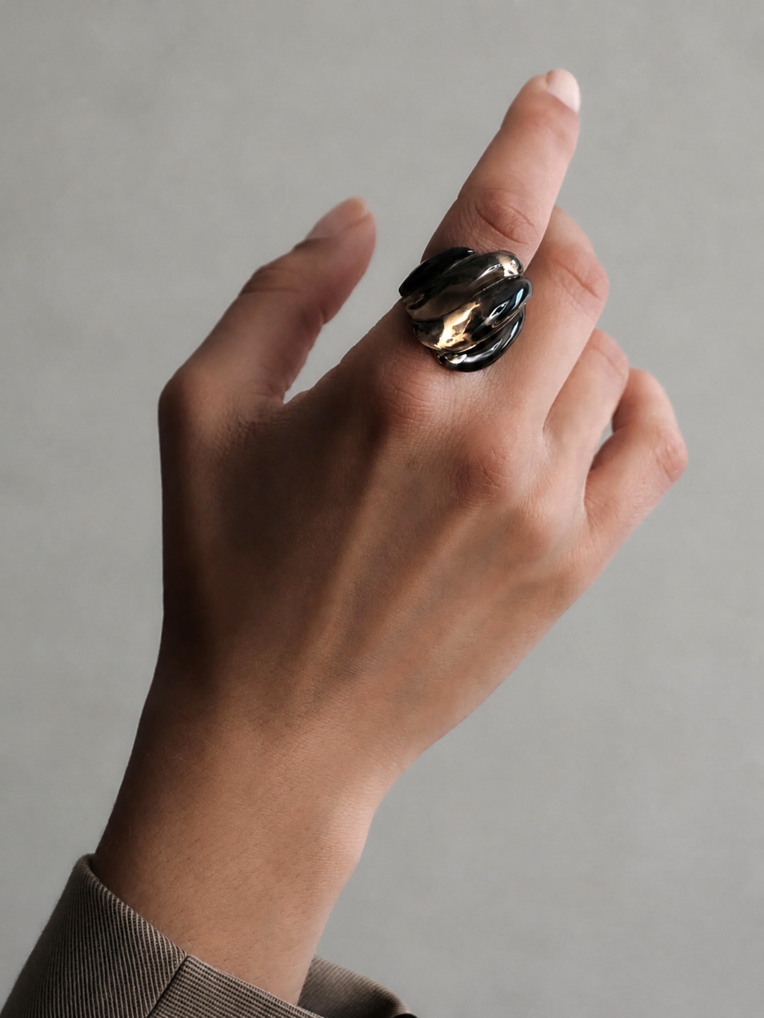 Fernando Jorge gold and gemstone rings on two hands
