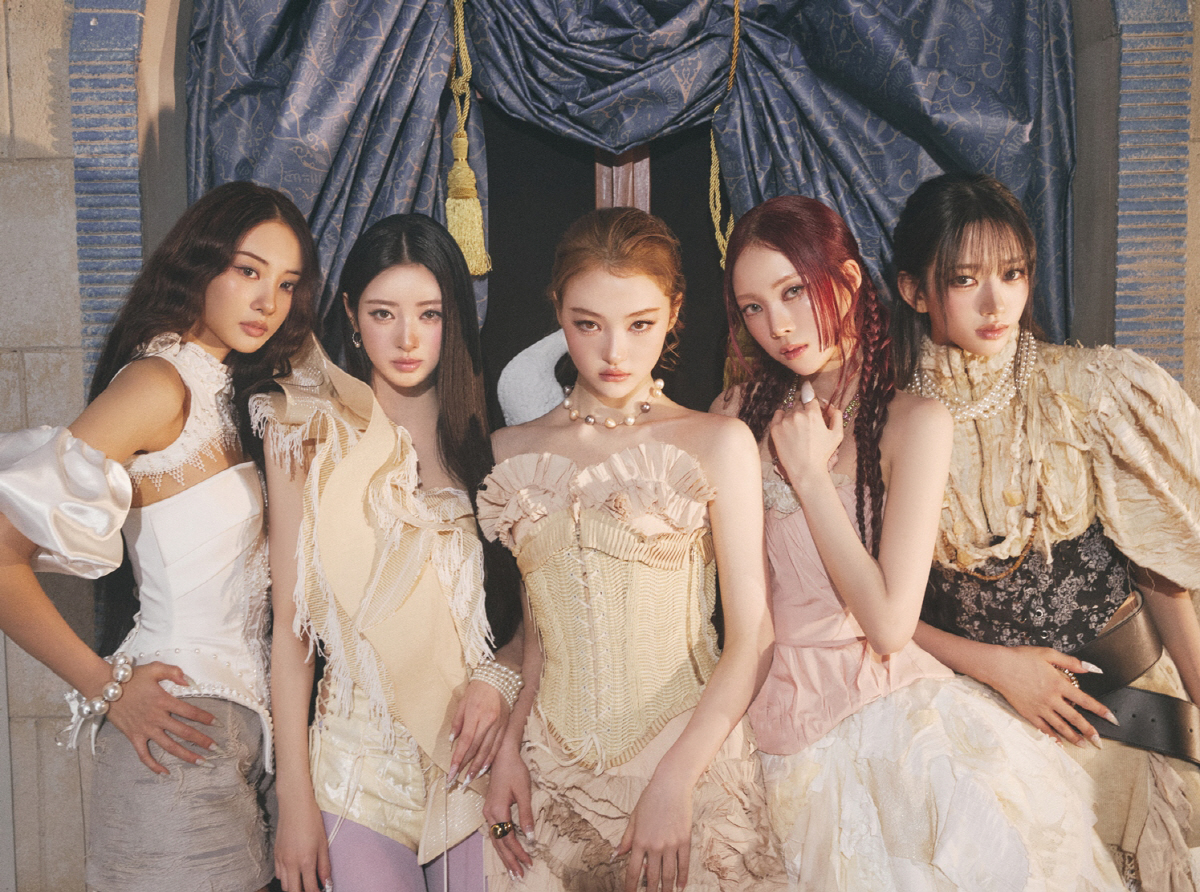 MEOVV members in pearl-trimmed corsetry and ornate court-inspired styling