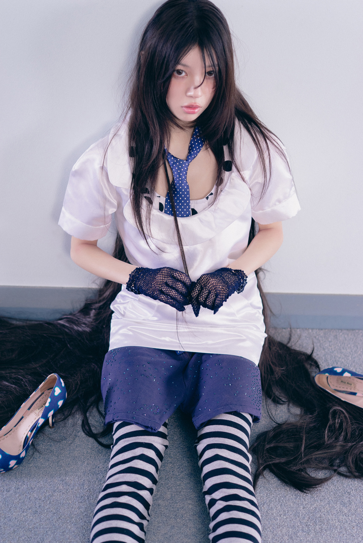 ILLIT Pink Bomb concept with a polka-dot tie, striped socks, heart shoes, and hazy styling