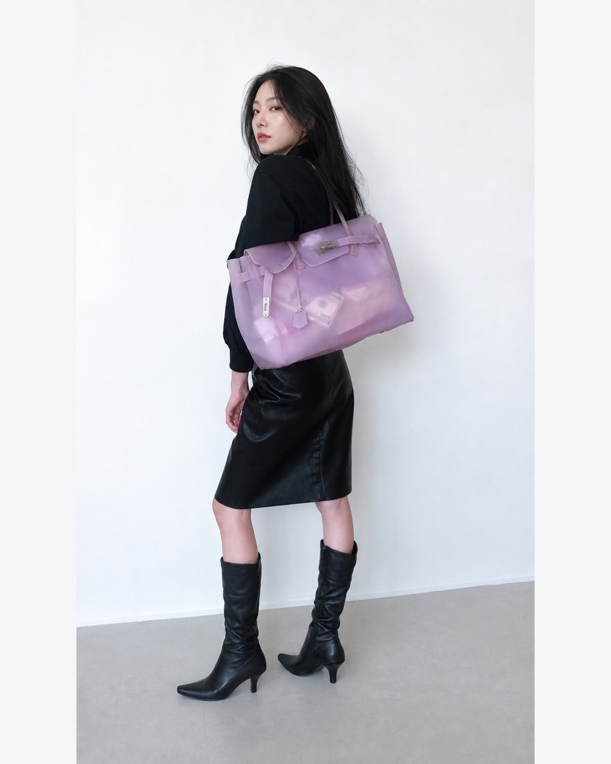 Translucent lavender jelly tote styled with a black top, leather skirt and knee boots