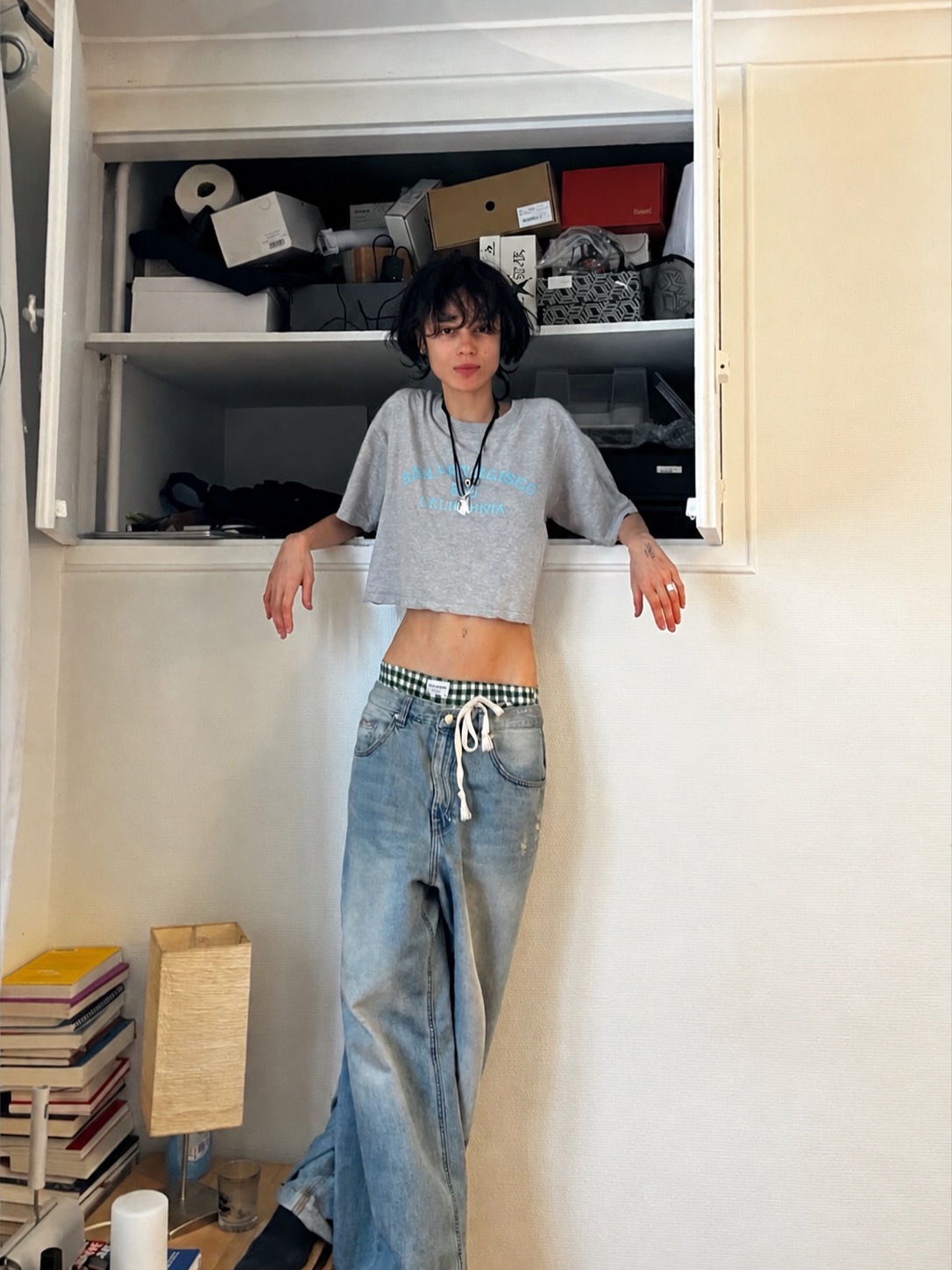 A genderless fashion look with layered proportions and quiet artist mood