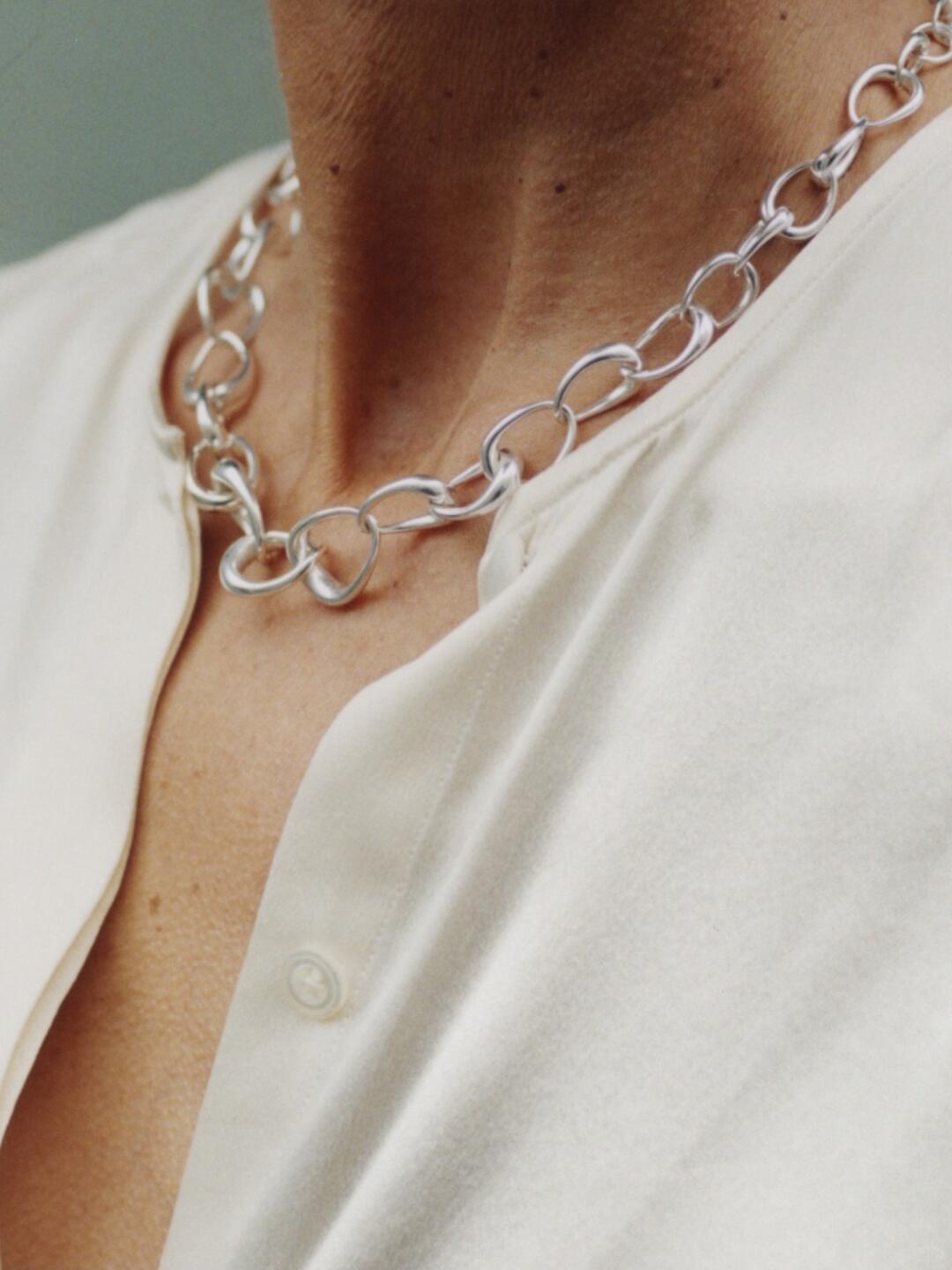 Silver Georg Jensen necklace worn against a white top
