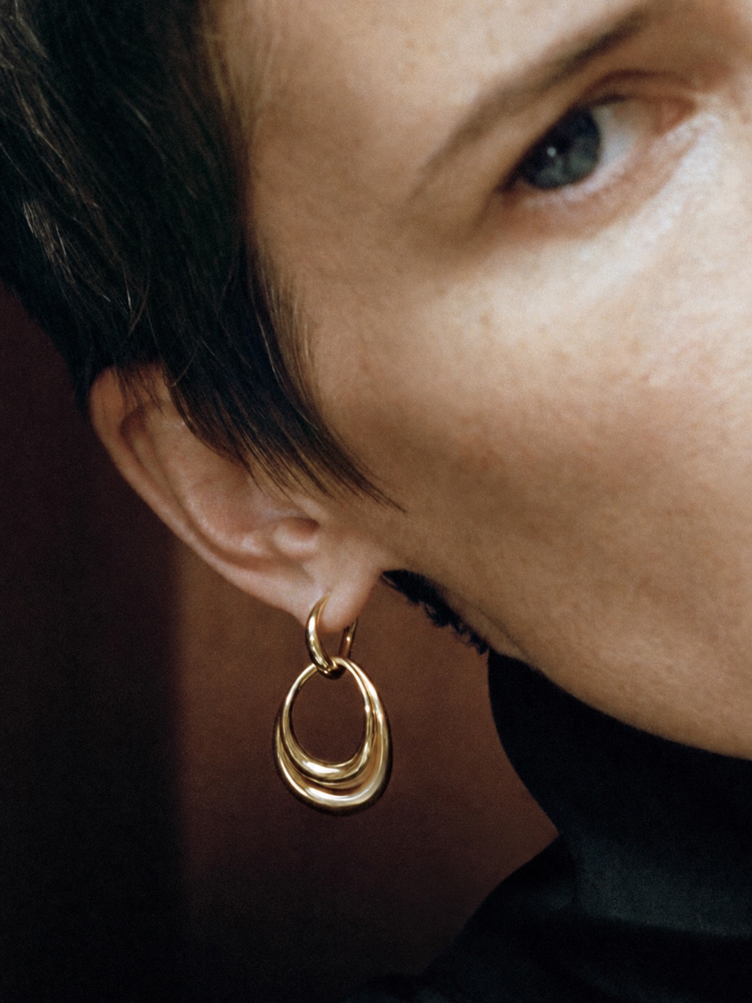 Circular gold Georg Jensen earring in close-up