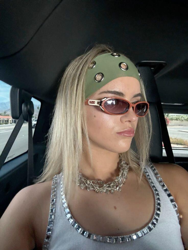 Wide black headband worn with loose hair and Y2K styling