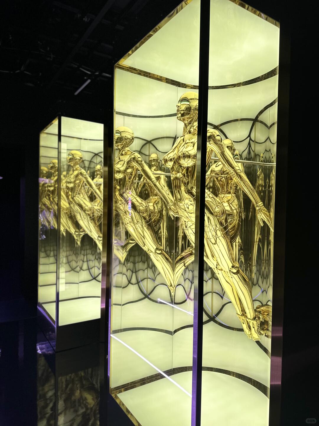 Chrome gynoid installation with multiple mirrored Sorayama robot figures