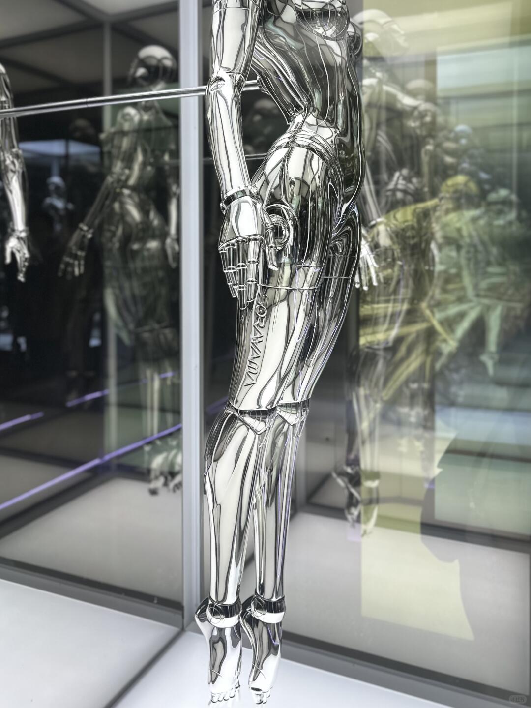 Close-up of chrome mechanical leg and reflective robot body detail
