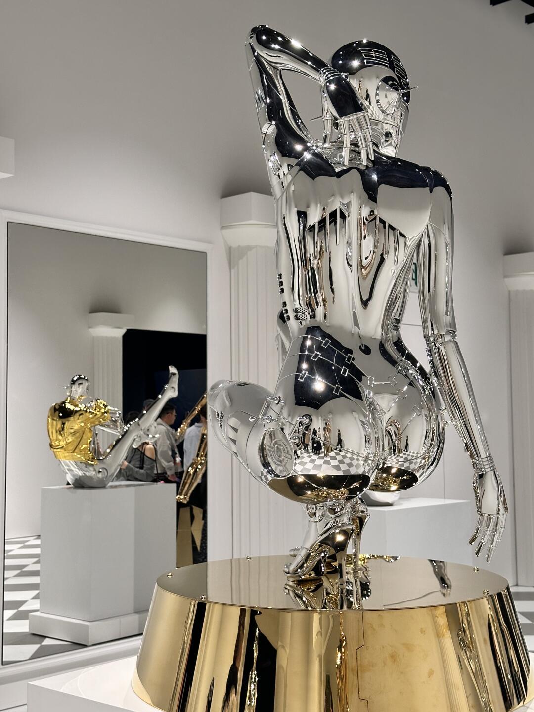 Black and silver chrome torso sculpture with exaggerated feminine form