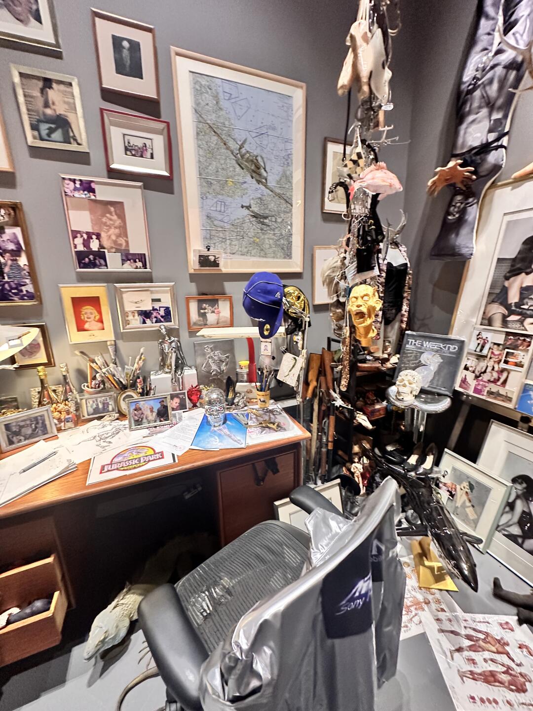 Dense studio room with Sorayama-related objects, models and visual references