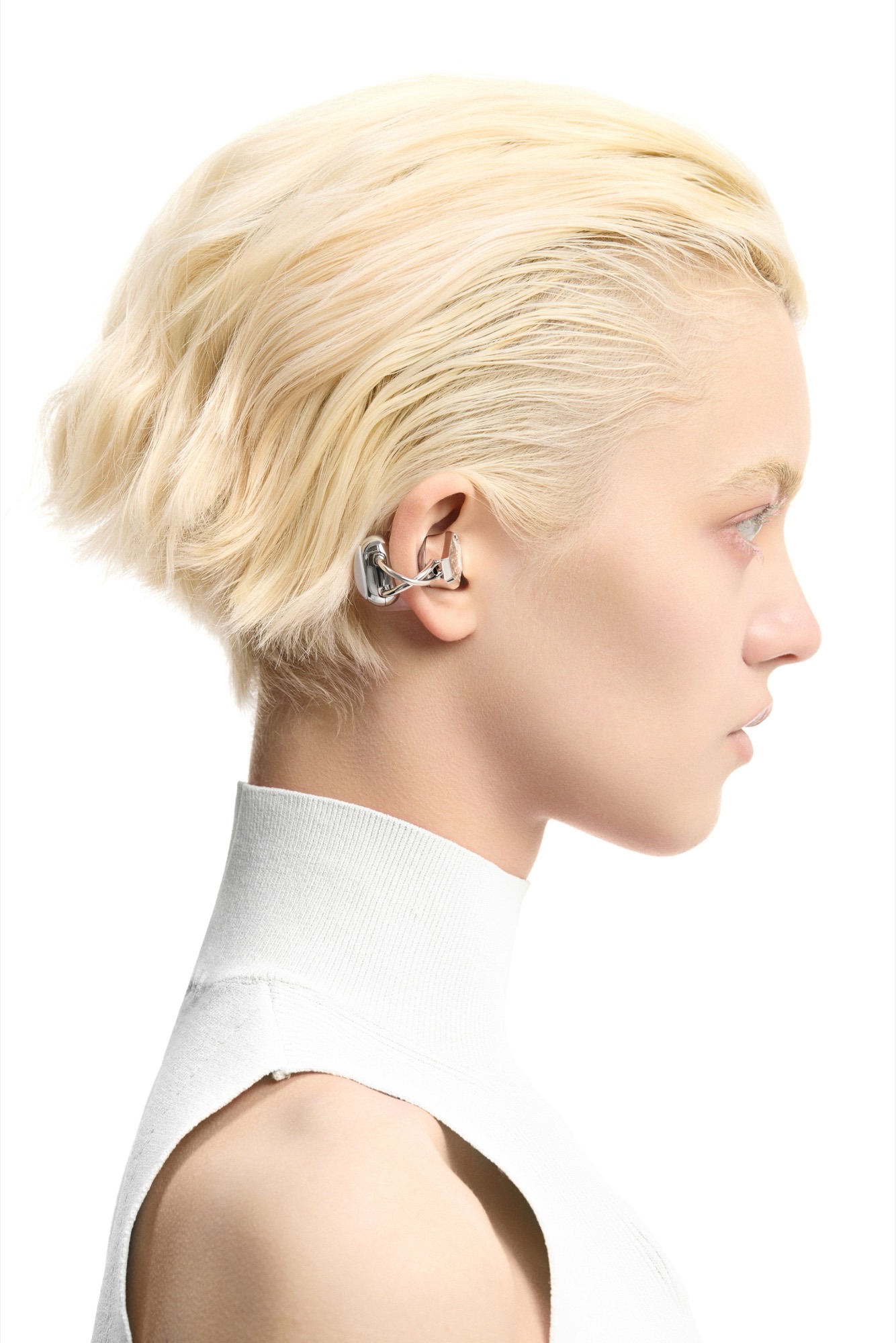 Side profile of a model wearing OF HUNGER Electronic Gems, showing the silver clip structure around the ear.