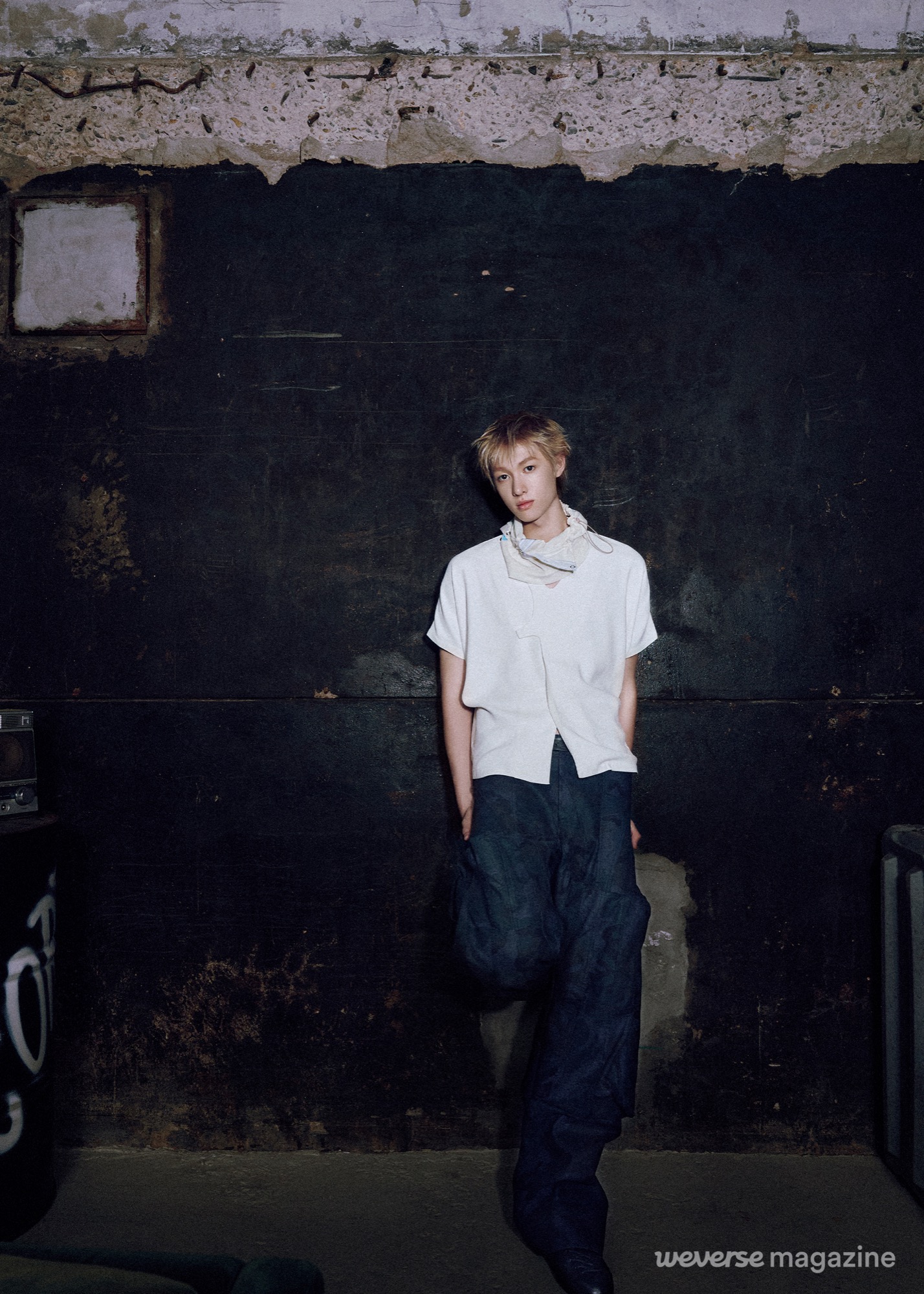 CORTIS member in a loose white top and extremely wide dark trousers