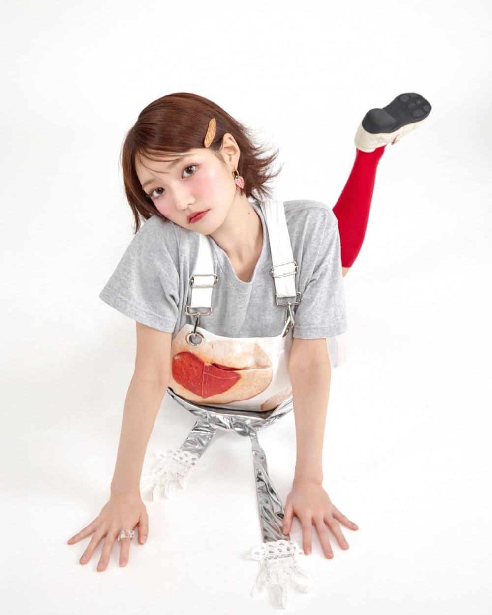 KiiiKiii member Jiyu wearing bright red knee socks with a grey and white outfit