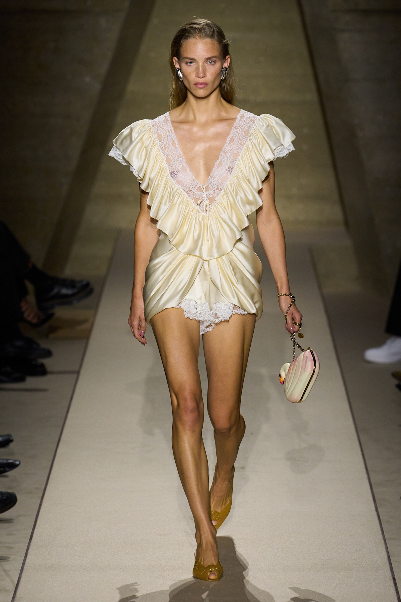 Chloé Spring 2026 runway look pairing an ivory lace dress with amber jelly mules