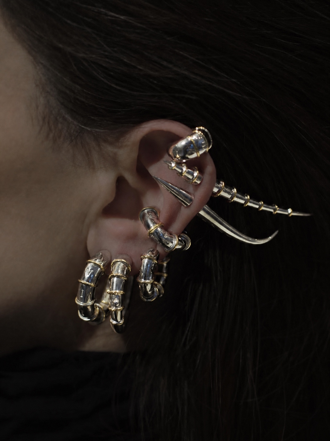 Dark Jaagravii ear cuff jewelry with silver and gold details