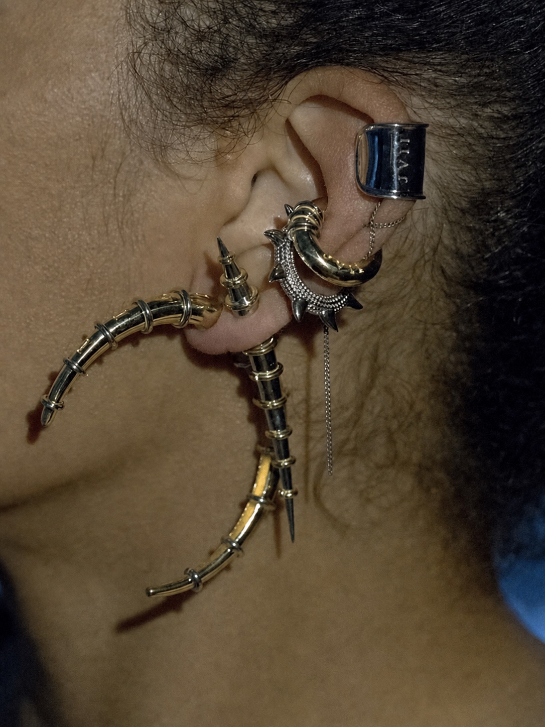 Sculptural Jaagravii ear cuff earrings with silver and gold tubes