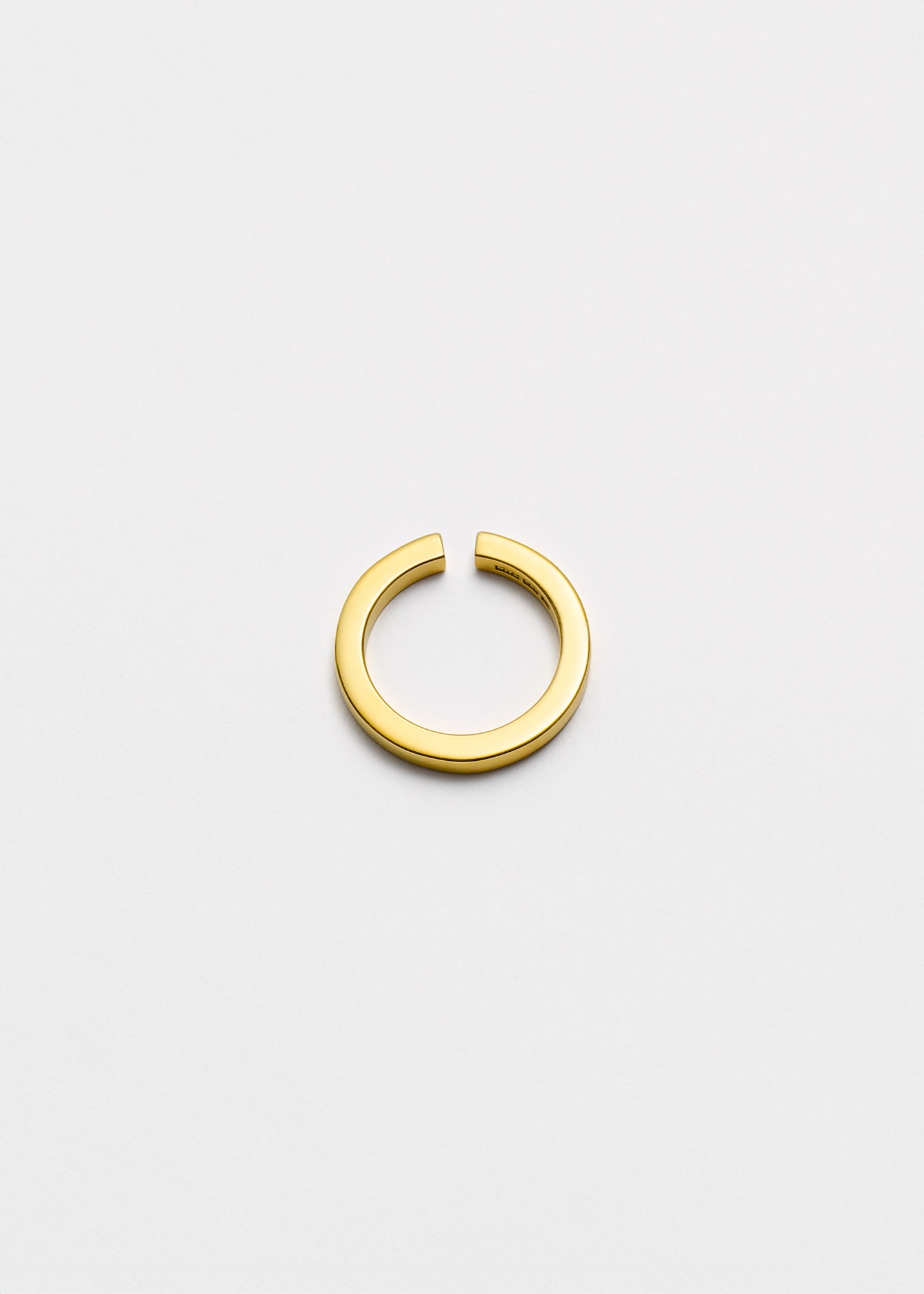 All Blues sculptural square gold ring photographed on a light background