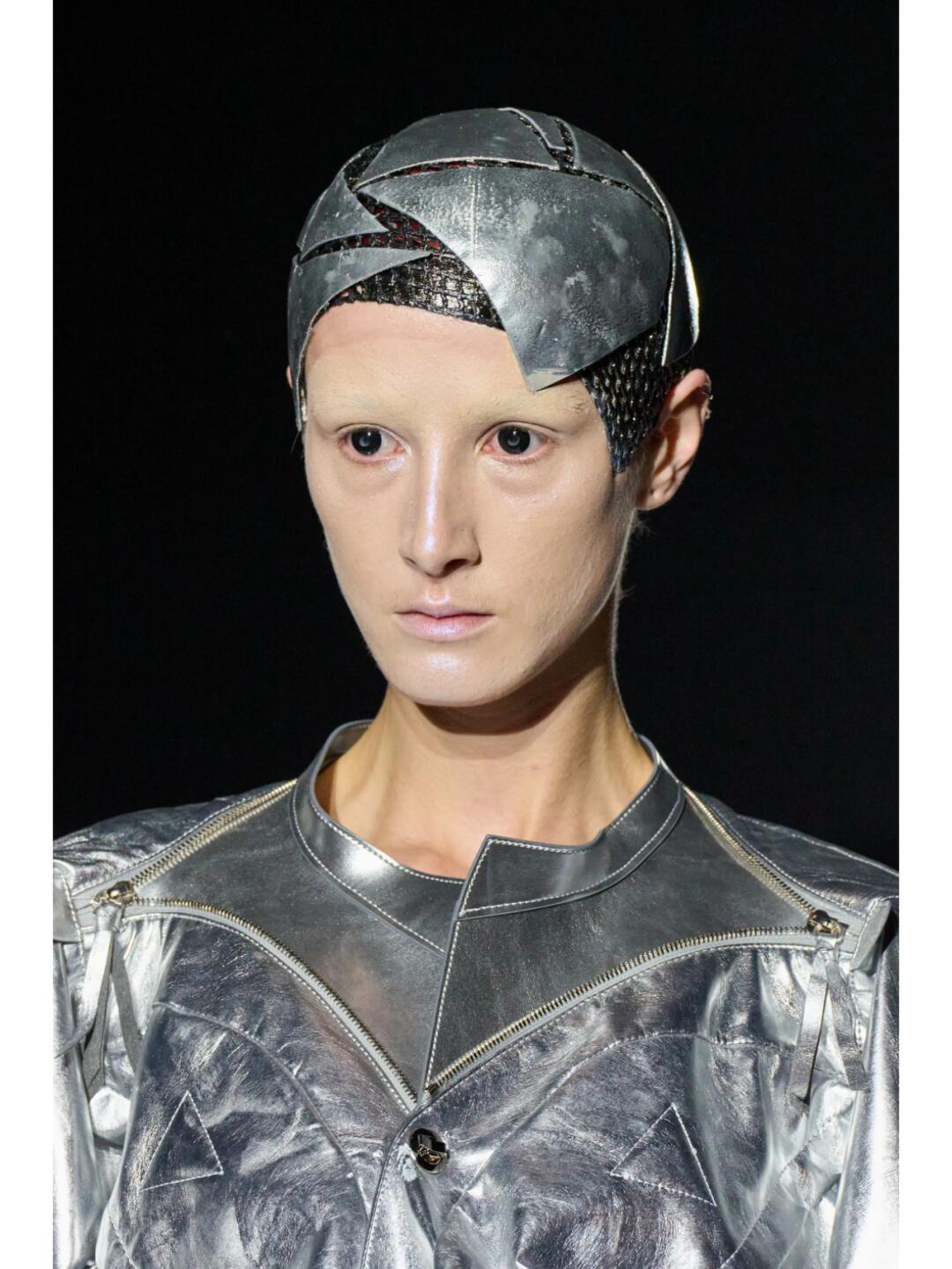 Close-up of a Junya Watanabe SS2025 metallic headpiece and translucent upper garment