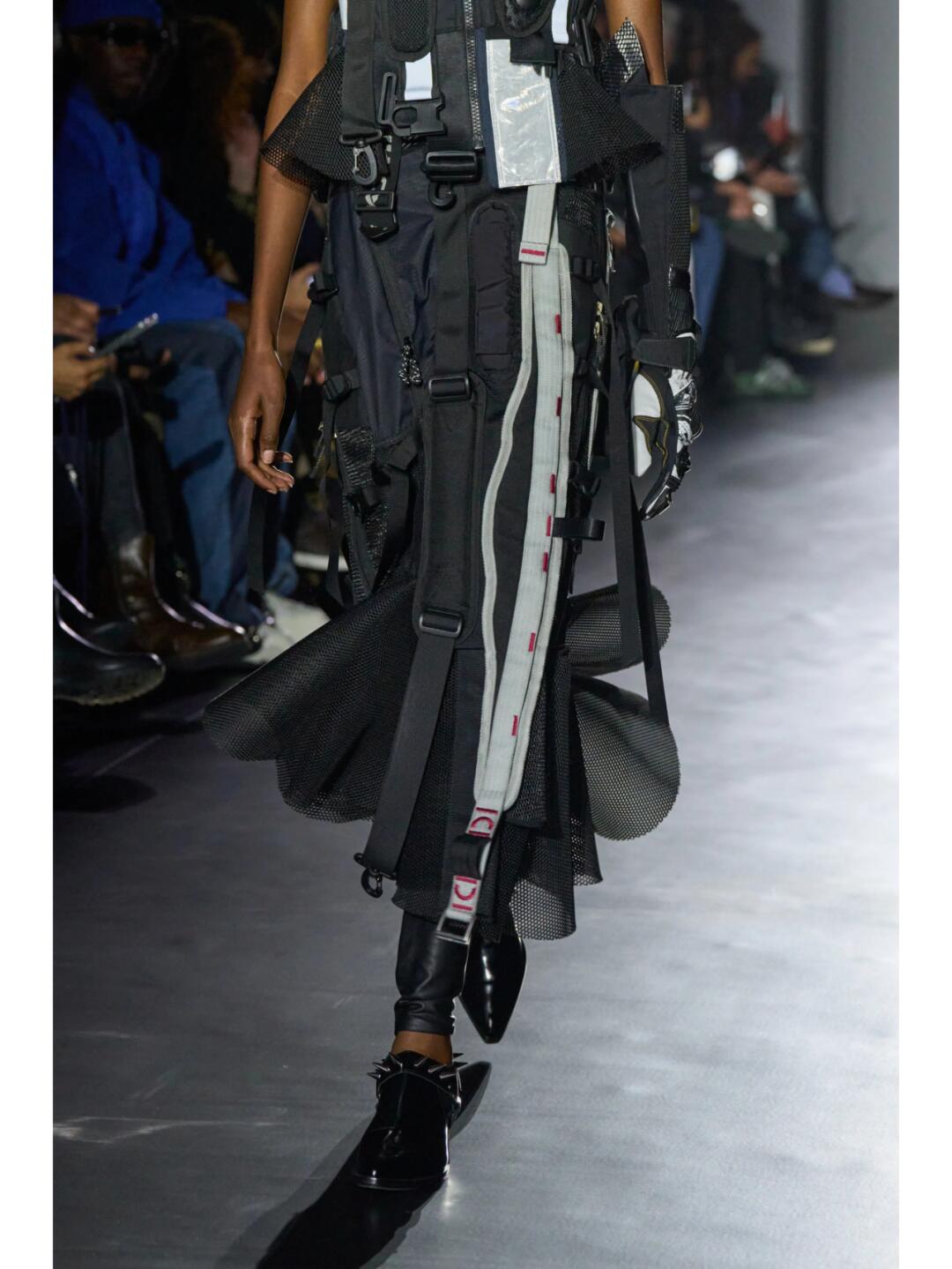 Narrow black Junya Watanabe SS2025 runway look with vertical hardware-like strips