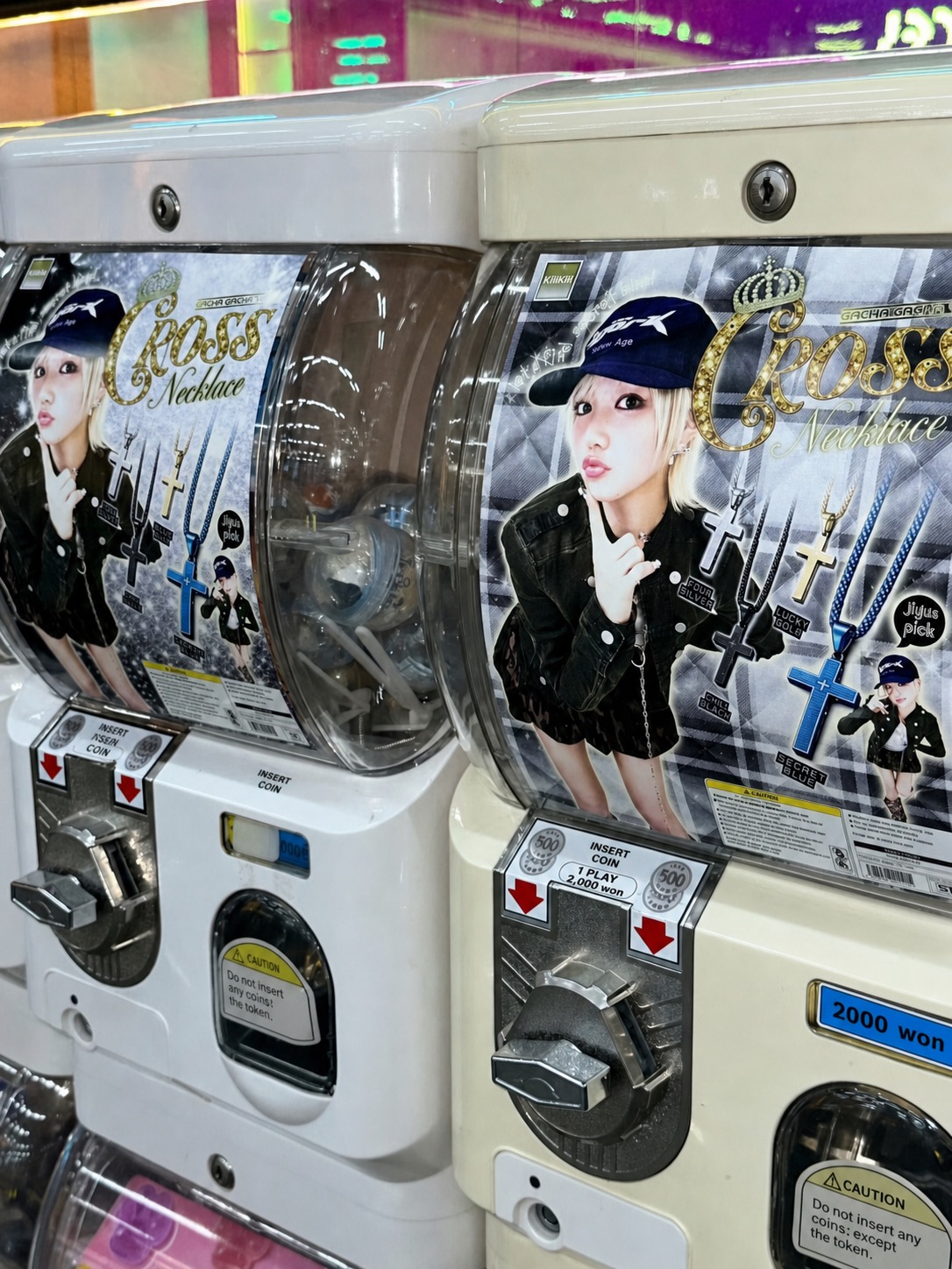 Gacha machines wrapped in KiiiKiii-style necklace graphics
