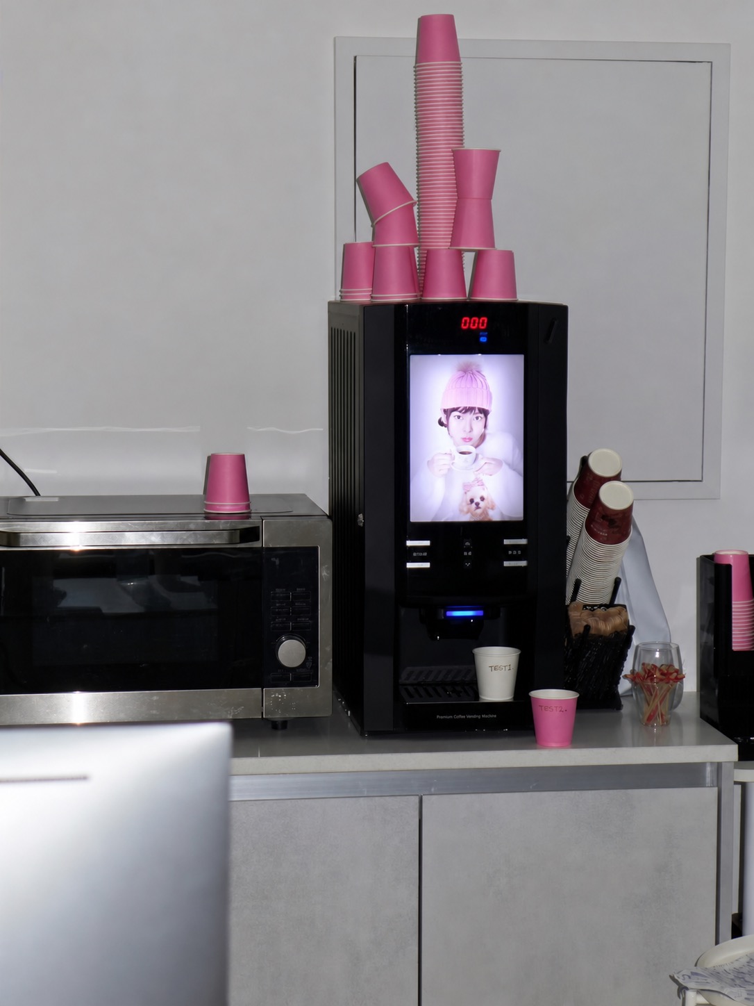 Pink cups stacked around a vending machine display