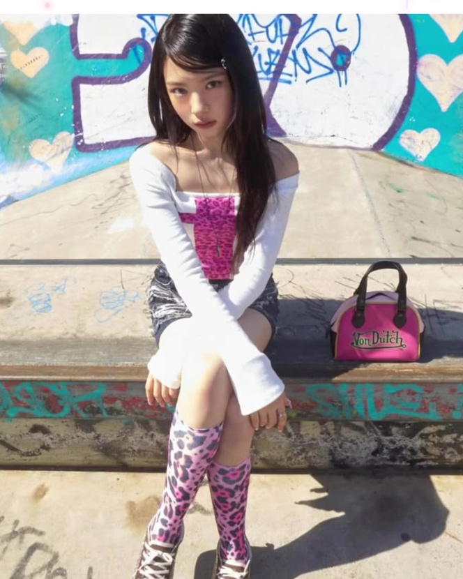 KiiiKiii-inspired conflict styling with patterned socks, platform shoes, and a pink bag.