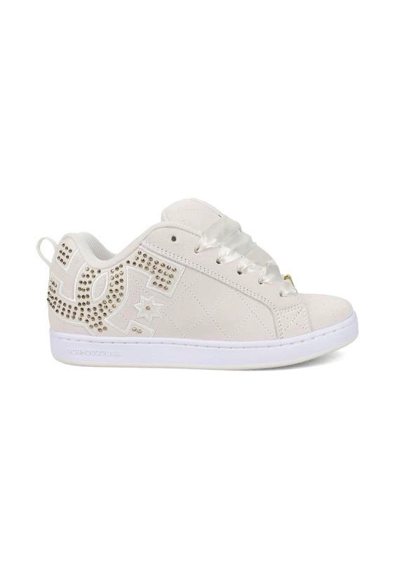Off-white low-top DC sneaker in side view, with a large stud-outlined logo and a white sole.