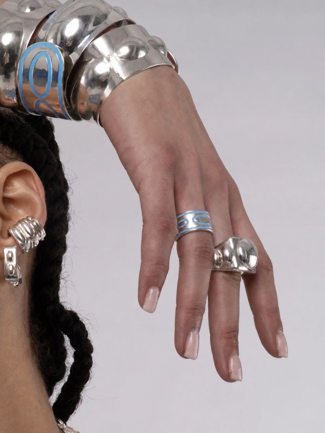 Silver and gold La Manso bracelet and rings in close-up
