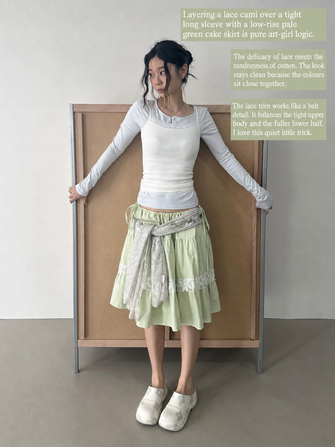 Pale green skirt outfit with white lace layers and low saturation styling
