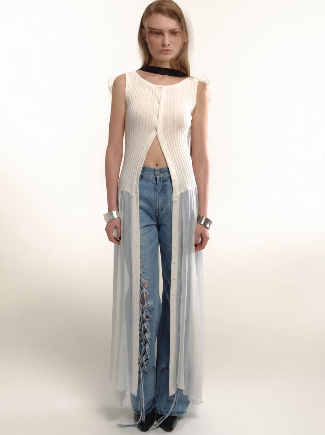 Low saturation outfit with white long top, jeans and silver cuffs