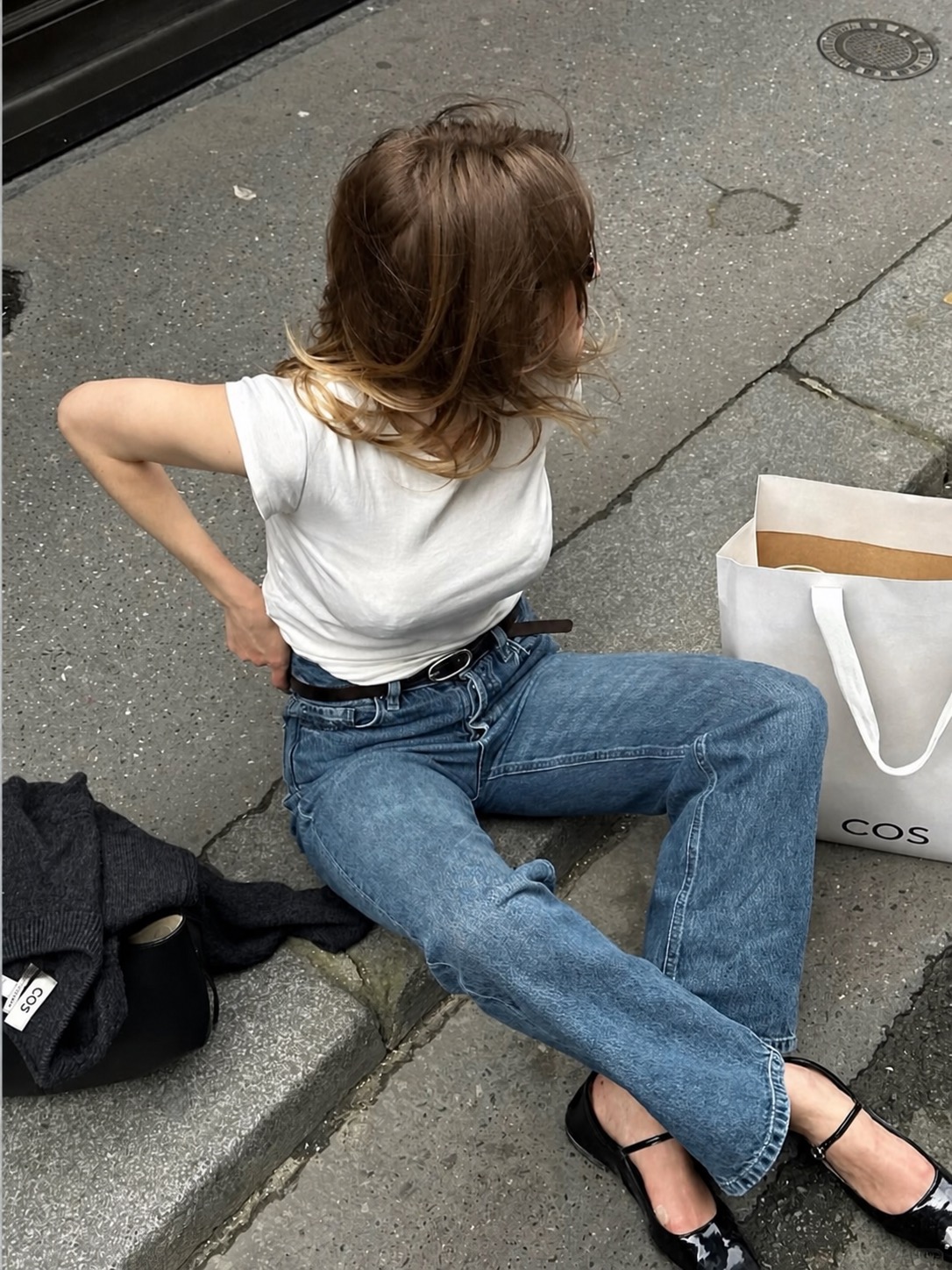 white pants outfit with delicate top and european summer styling