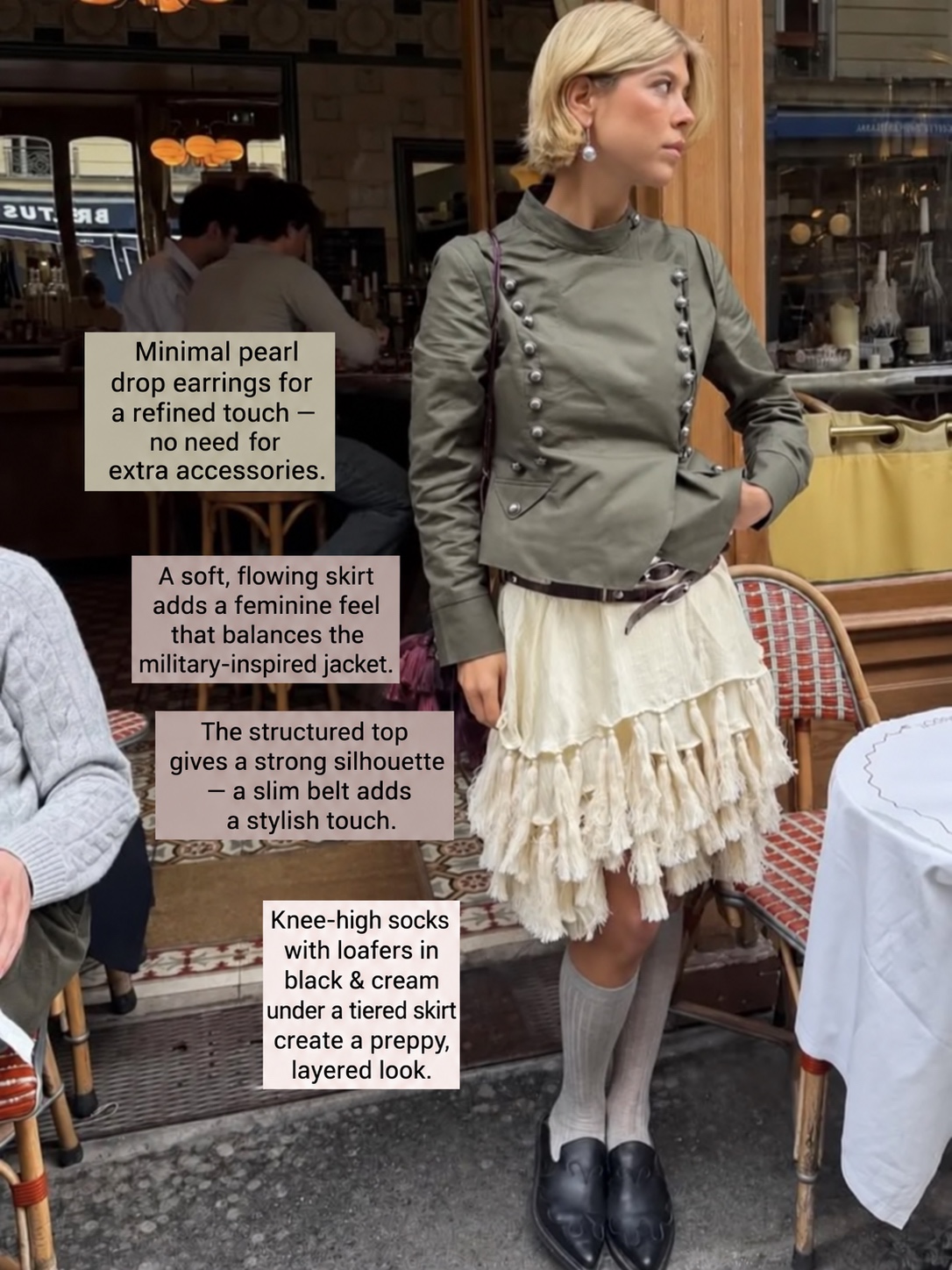Olive military jacket with a tiered cream skirt and black loafers